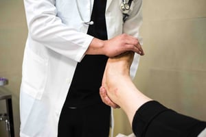 Doctor holding foot